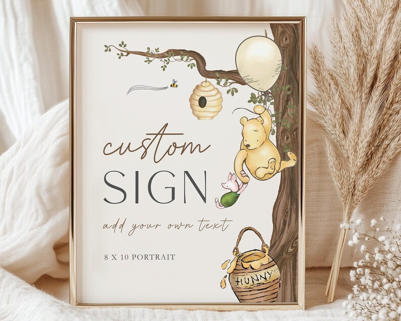 May include: A framed custom sign with a Winnie the Pooh theme. The sign features illustrations of Pooh, Piglet, a beehive, and a honey pot. The text reads "custom SIGN" and "add your own text". The sign is 8 x 10 inches.