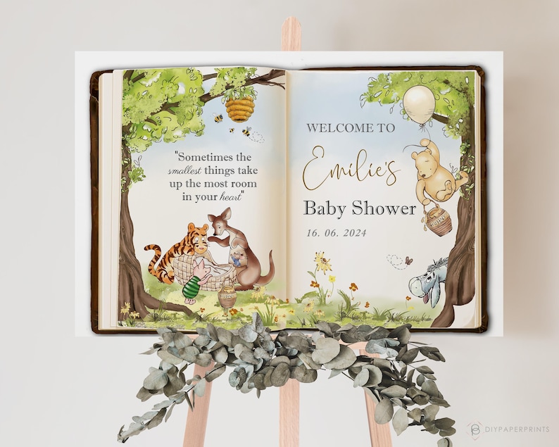 May include: A baby shower sign featuring a Winnie the Pooh theme. The sign is designed to look like an open book, with illustrations of Pooh, Tigger, and other characters. The text reads "Welcome to Emilie's Baby Shower 16.06.2024."