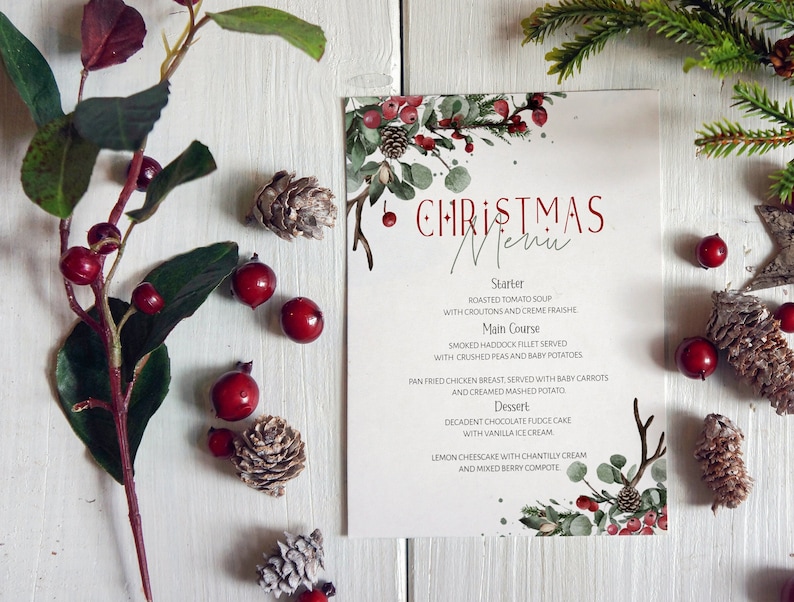 May include: A Christmas menu with a watercolor design of red berries, green leaves, and a white background. The menu includes a starter, main course, and dessert. The text reads: "CHRISTMAS Menu".