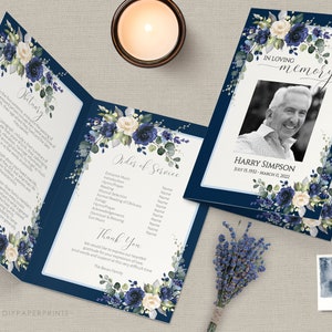 May include: A navy blue funeral program with white and blue floral designs. The program includes an obituary, order of service, and a thank you message. The program also features a photo of the deceased, Harry Simpson, with the dates July 15, 1932 - March 11, 2022.