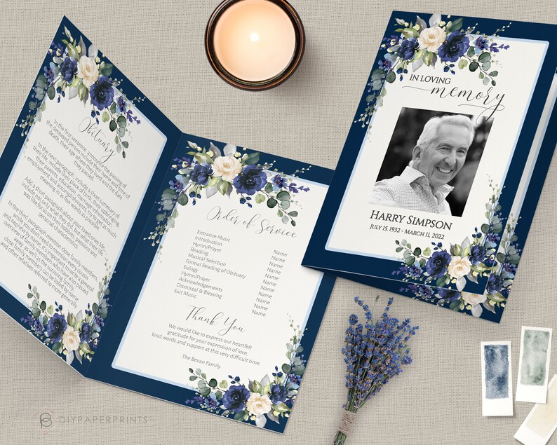 May include: A navy blue funeral program with white and blue floral designs. The program includes an obituary, order of service, and a thank you message. The program also features a photo of the deceased, Harry Simpson, with the dates July 15, 1932 - March 11, 2022.