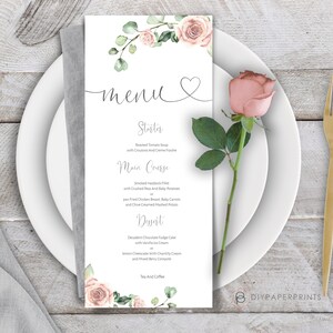 May include: A printable wedding menu template with a floral design. The menu features a heart symbol and the word "menu" in cursive. The menu lists the following items: Starter, Roasted Tomato Soup with Croutons and Cr&egrave;me Fraiche; Main Course, Smoked Haddock Fillet with Crushed Peas and Baby Potatoes or Pan Fried Chicken Breast, Baby Carrots and Chilled Creamed Mashed Potato; Dessert, Decadent Chocolate Fudge Cake with Vanilla Ice Cream, Lemon Cheesecake with Chantilly Cream and Mixed Berry Compote; Tea and Coffee.