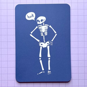 May include: A white skeleton with a speech bubble that says "heck" on a blue background.