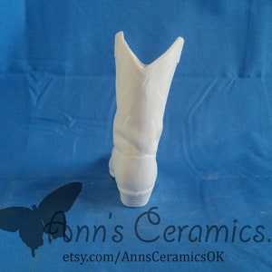May include: White ceramic cowboy boot planter. The boot is unpainted and ready to be decorated.