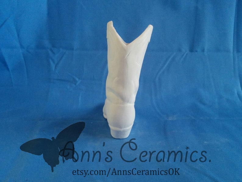 May include: White ceramic cowboy boot planter. The boot is unpainted and ready to be decorated.