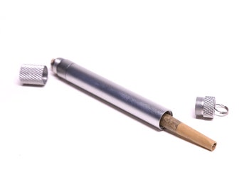 May include: A silver metal tube with a brown paper tube inside. The metal tube has a cap on each end. The tube is open on one end, revealing the brown paper tube.