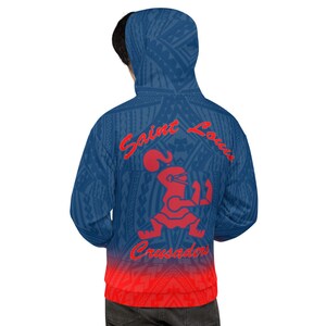 May include: Blue hoodie with a tribal pattern and a red gradient at the bottom. The back features the words "Saint Louis Crusaders" in red, along with a red graphic of a figure.