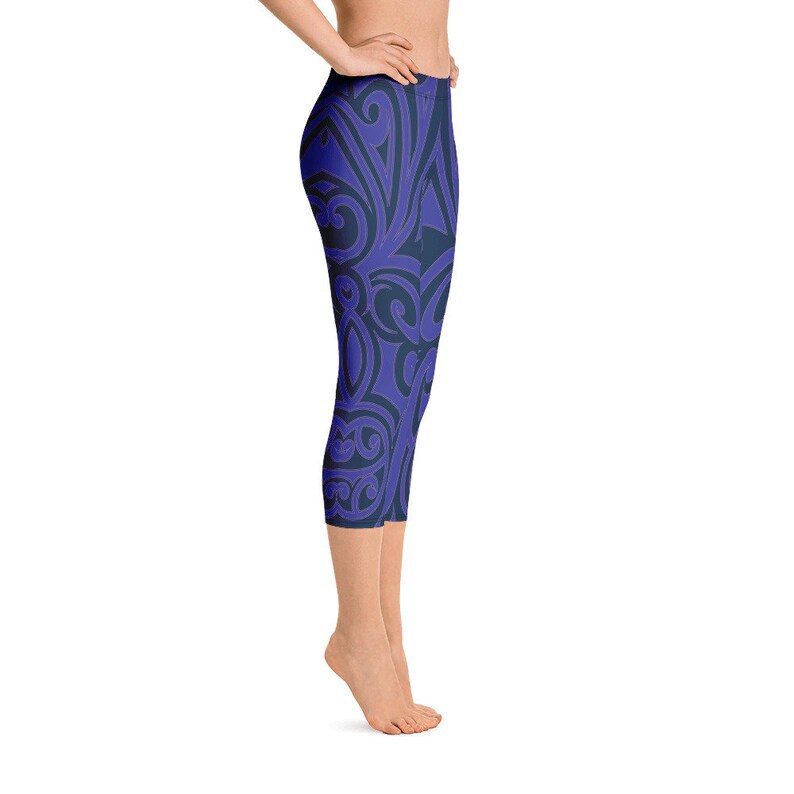 May include: Blue and navy capri leggings with a repeating, swirling pattern. The leggings are made of a stretchy material and are designed to be worn during workouts or as casual wear.