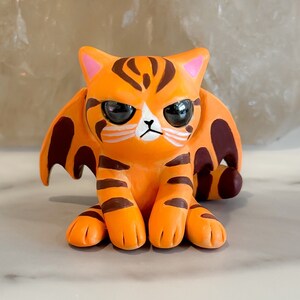 Orange dragon tabby cat sculpture