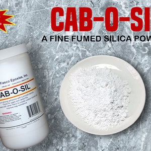 May include: A white plastic container with a red and white label that reads "FASCO Epoxies" and "CAB-O-SIL". The container is filled with a white powder. The label also states "A FINE FUMED SILICA POWDER".