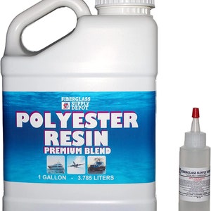 May include: A white gallon jug of polyester resin with a blue and white label that says "Fiberglass Supply Depot Polyester Resin Premium Blend 1 Gallon - 3.785 Liters". A small clear bottle of catalyst is next to the jug.
