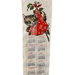 May include: A vintage linen calendar for the year 1979 featuring a cute cartoon kitten peeking out of a red bandana. The calendar is divided into 12 months with each month displayed in a separate box.