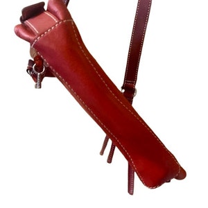 May include: A red leather crossbody bag with a white stitch detail and a silver zipper pull.