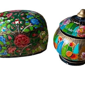 May include: Two decorative boxes with intricate floral patterns in shades of green, blue, red, and gold. The boxes are made of papier-mâché and have a traditional Indian design.