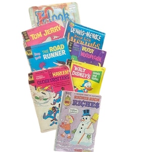 May include: A stack of vintage comic books featuring characters like Tom and Jerry, Dennis the Menace, Woody Woodpecker, and Walt Disney. The comic books have colorful covers with illustrations of the characters.