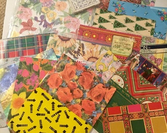 May include: A collection of vintage wrapping paper featuring various patterns, including floral, plaid, geometric, and a bingo card. The paper is in various colours, including red, green, blue, yellow, and white.