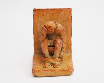 Lost on the loo - ceramic sculpture
