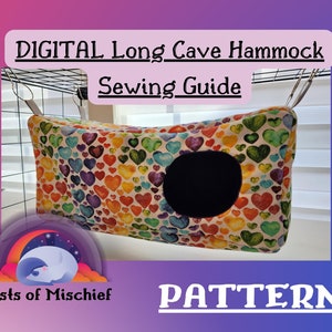 May include: A long cave hammock for small pets, decorated with watercolor hearts in various colours. The hammock has a black circular opening and is suspended from a wire cage. Text reads "DIGITAL Long Cave Hammock Sewing Guide" and "PATTERN".