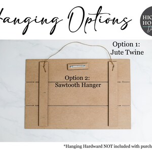 May include: The back of a wooden sign with two hanging options: jute twine and a sawtooth hanger. The text "Hanging Options" is written at the top of the sign. The text "Option 1: Jute Twine" and "Option 2: Sawtooth Hanger" is written on the sign. The text "*Hanging Hardware NOT included with purchase of 4x6" is written at the bottom of the sign.