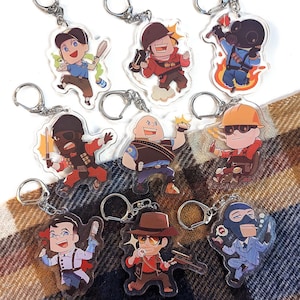 Peut inclure: Une collection de porte-clés en acrylique représentant des personnages de dessins animés dans diverses poses d'action. Chaque porte-clés est doté d'un anneau en métal argenté. Les personnages portent différentes tenues et tiennent divers objets.