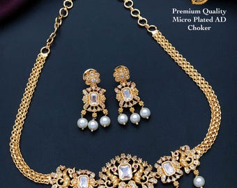 South indian style gold choker necklace designs| peacock pendant choker necklace with pearl drops and ad stones| american diamond necklace