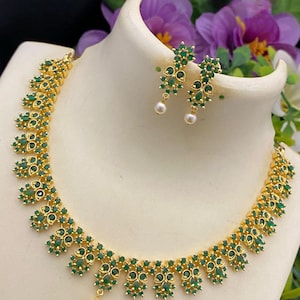 South indian cz necklace jewelry design | american diamond choker necklace set | gold tone emerald necklace | ruby stone flower necklace