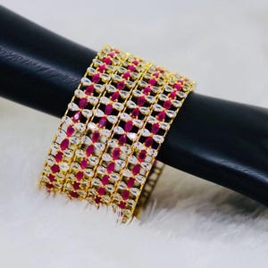 Indian style 22k gold zircon bangles studded with clear ruby pink topaz cubic zirconia