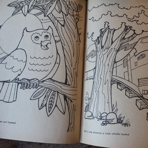 May include: A black and white illustration of an owl perched on a branch with a large moon in the background. The text "The sun quickly set, an owl hooted." is below the owl. On the right side of the page, a black and white illustration of a train on tracks with a tree in the background. The text "Off in the distance a train whistle tooted." is below the train.