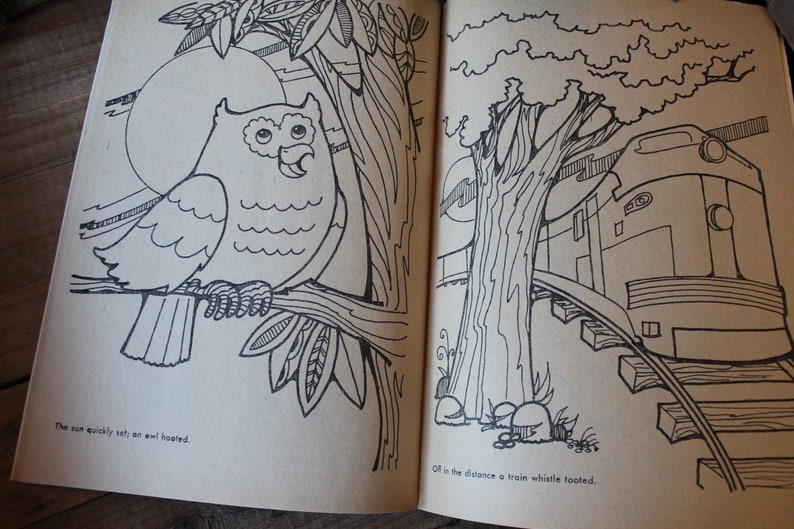May include: A black and white illustration of an owl perched on a branch with a large moon in the background. The text "The sun quickly set, an owl hooted." is below the owl. On the right side of the page, a black and white illustration of a train on tracks with a tree in the background. The text "Off in the distance a train whistle tooted." is below the train.