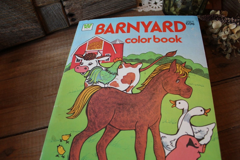 May include: A vintage coloring book with a red barn, a brown horse, a cow, a rooster, and two yellow chicks. The book is titled "BARNYARD color book" and costs 69 cents.