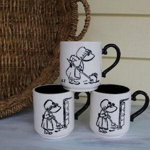 1970s Holly Hobbie Hand Painted Coffee Cups, Holly Hobbie Does Chores, Vintage Embossed Black & White Mugs, Holly Hobbie Cleaning House