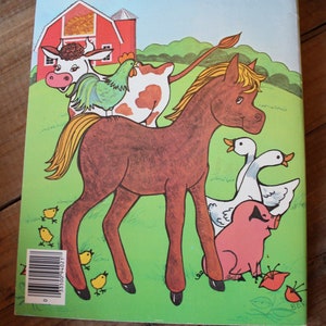 May include: A brown horse with a blonde mane stands on a green field with a red barn in the background. A cow with brown and white spots, a rooster, and a pig are also in the image. There are several yellow chicks on the ground.