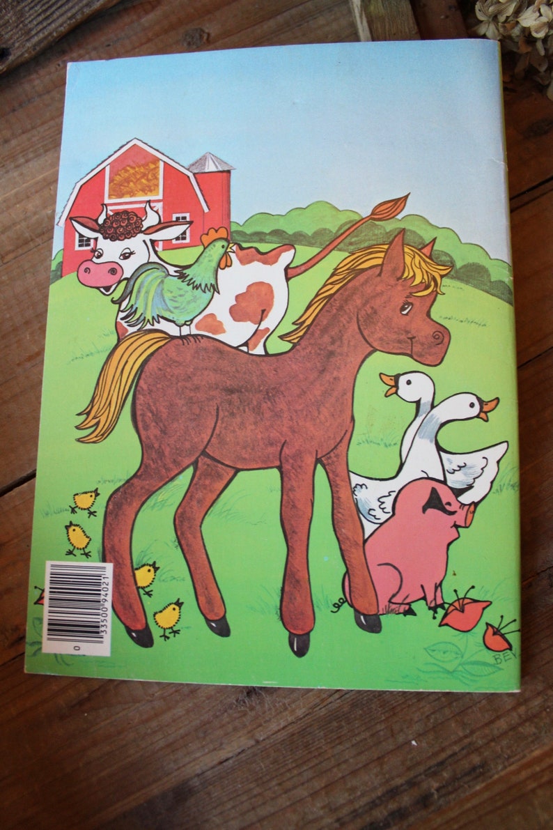 May include: A brown horse with a blonde mane stands on a green field with a red barn in the background. A cow with brown and white spots, a rooster, and a pig are also in the image. There are several yellow chicks on the ground.