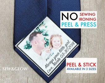 May include: A blue necktie with a white square patch that says "No Sewing, Ironing, Peel & Press" and has a photo of a man and a young girl with the text "Always your little girl. Love, Nicole 03-30-2018" and "Peel & Stick Available in 3 Sizes".