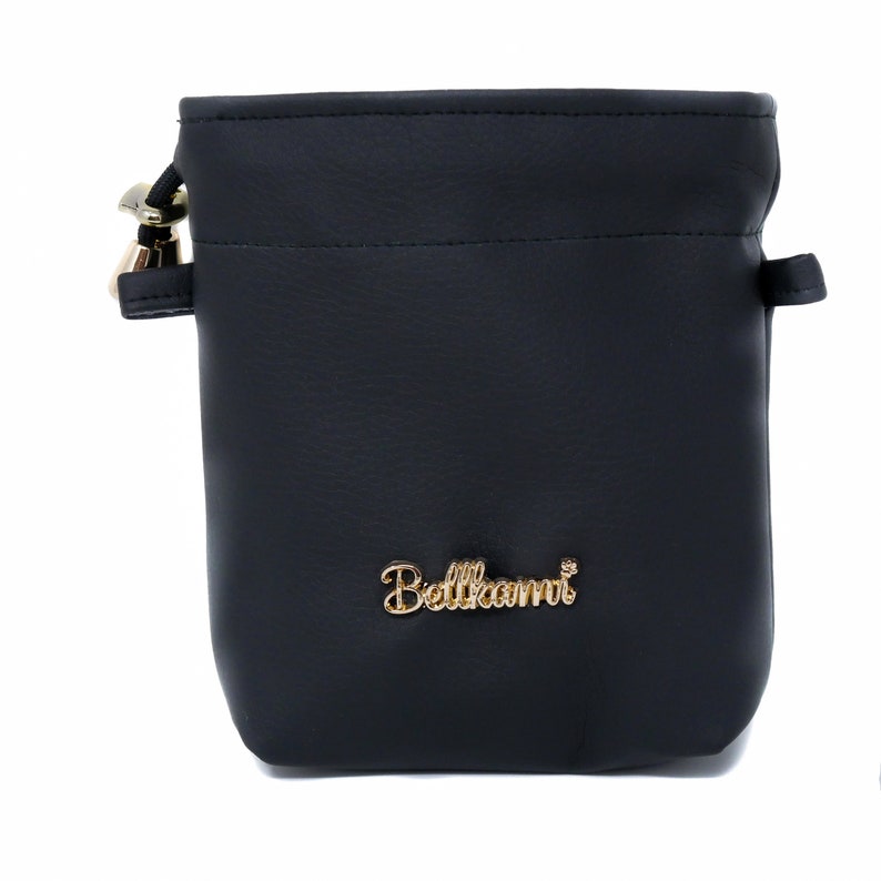 May include: Black leather drawstring bag with a gold metal logo that says "Bellami".