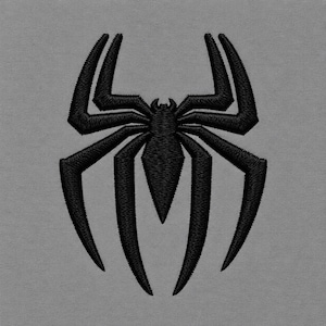 May include: A black embroidered spider emblem featuring a central pointed body and eight angular, elongated legs. The design is stitched with a visible thread texture, creating a raised appearance against a solid, flat, neutral gray fabric background.