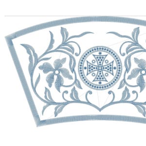 May include: A detailed embroidery design in shades of blue on a white background. The design features floral and foliate motifs, along with a central circular element with a cross. The design is likely for fabric or textile applications.
