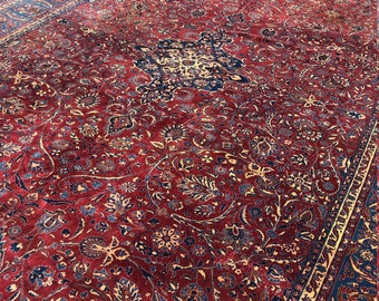 May include: A red, blue and gold Persian rug with a floral pattern. The rug has a central medallion and a border.