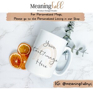 May include: White ceramic mug with a rainbow design and the text "Your text/image Here." The mug is part of the "Meaning Full Product Design Studio" collection. The image also includes dried orange slices and greenery.
