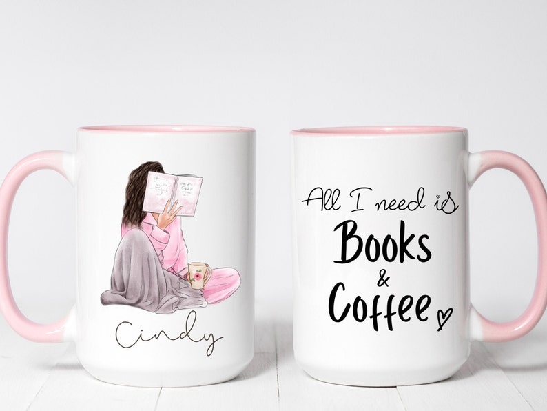 May include: White ceramic mug with a pink interior and handle. One side features an illustration of a person reading, the name "Cindy" is written below. The other side says "All I need is Books & Coffee" in black script.