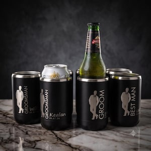 May include: A set of four matte black cylindrical beverage insulators. Each features a laser-engraved silhouette of a person in a suit, along with titles like Groomsman, Groom, and Best Man, plus names and dates. One holds a beer bottle.