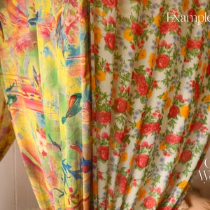 May include: Two sheer curtains with floral patterns. The curtain on the left has a colorful abstract design with birds and flowers. The curtain on the right has a white background with red, yellow, and green flowers. The text "Colors & Weaves India" is visible in the bottom right corner.