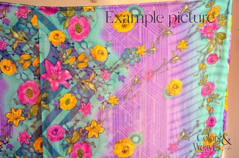 May include: A colorful fabric with a floral pattern in shades of pink, yellow, and green. The fabric has a gradient background that transitions from purple to blue. The text "Example picture" is printed in the upper right corner of the fabric. The text "Colors & Weaves India" is printed in the lower right corner of the fabric.