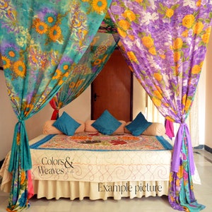 May include: A bed with a canopy made of colorful floral patterned fabric. The canopy is draped over the bed and tied at the corners. The bed has a white bedspread and a patterned throw pillow. The text "Colors & Weaves" is visible on the bedspread. The text "Example picture" is visible at the bottom of the image.