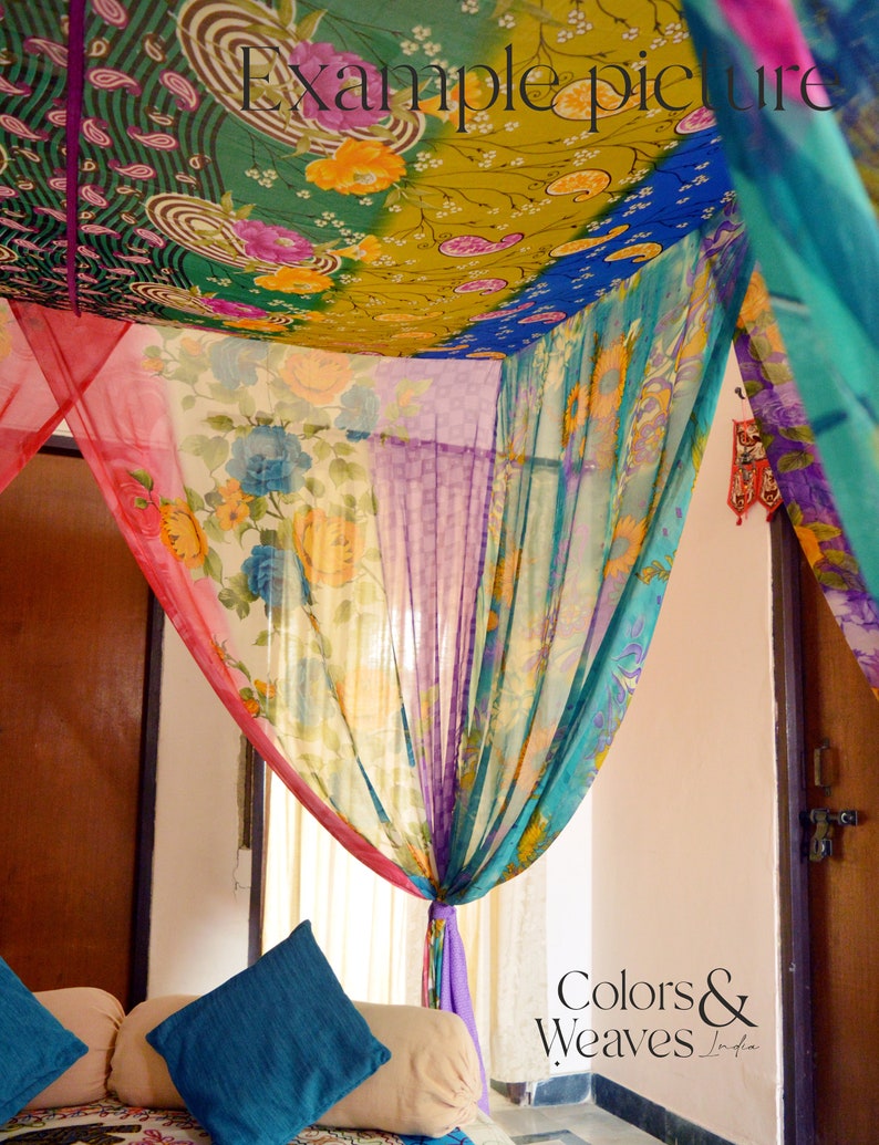May include: A colorful canopy made of fabric with floral patterns hangs over a couch with two blue pillows. The fabric is draped in a way that creates a sense of privacy and intimacy. The text "Colors & Weaves India" is visible in the bottom right corner of the image.