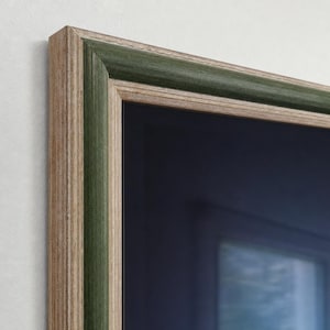 May include: A rectangular picture frame featuring a layered design with a natural light wood grain finish on the outer and inner edges, contrasted by a deep forest green painted band running through the center of the frame molding.