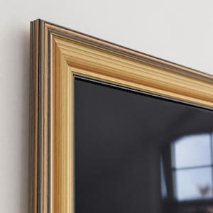 May include: A rectangular picture frame featuring a multi-layered wood grain finish with alternating bands of light tan, golden yellow, and dark brown tones. The frame has a deep profile with a smooth, angled inner edge surrounding a black center.