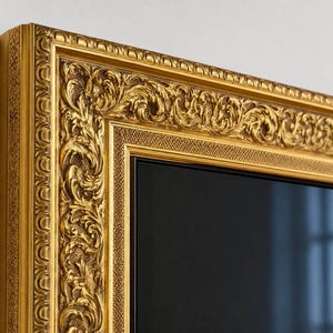May include: A rectangular mirror featuring a wide, ornate gold frame with intricate scrollwork and leaf-like carvings. The frame has a textured, layered border design with a deep metallic finish, surrounding a smooth, reflective black glass surface.