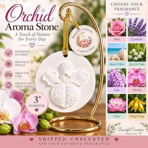 May include: A white circular aroma stone featuring a raised orchid relief, suspended by a gold cord from a gold metal stand. The stone measures 3 inches in diameter. A round tag reads Beautiful Creations Crafts by Petra. Text includes Orchid Aroma Stone.