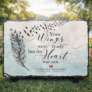 May include: A rectangular slate memorial plaque with the text "Your Wings were ready but my Heart was not." A black feather and flock of birds are depicted. The plaque includes a name and dates, and a red heart.